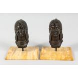 FRECOURT. A PAIR OF BRONZE EGYPTIAN HEAD CAR MASCOTS on stands. 4.5ins high.