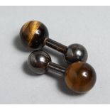 A PAIR OF SILVER AND TIGER'S EYE CUFF STUDS.