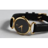 A LADIES YELLOW GOLD EBEL WRISTWATCH AND STRAP in original leather sleeve.