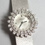 A LADIES 18CT WHITE GOLD LONGINES WRISTWATCH with a diamond set double bezel and mesh strap.