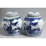 A GOOD PAIR OF CHINESE BLUE AND WHITE GINGER JARS AND COVERS. 10ins high.