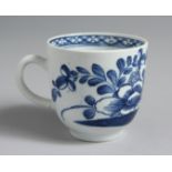 A BOW COFFEE CUP painted with a bird and flowers, the interior with a diaper border.