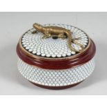 A PORCELAIN CIRCULAR BOX AND COVER with lizard handle. 5ins diameter.