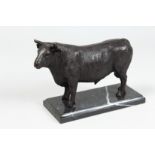 A BRONZE BULL on a marble base. 9ins long.