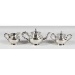 A CHINESE SILVER TEA SET engraved with birds with bamboo pattern handles and spout, comprising