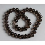 A SMOKEY QUARTZ BEAD NECKLACE.