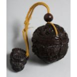 A JAPANESE CARVED WOOD BALL INRO on a rope. 2ins