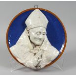 A GOOD DELLA ROBBIA TYPE CIRCULAR PLAQUE, blue background, a Pope in relief 12ins diameter.