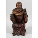 A 17TH CENTURY, POSSIBLY ITALIAN CARVED POLYCHROME FIGURE OF MOSES holding a tablet. 18ins high.