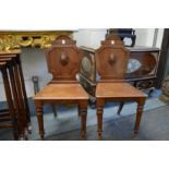 A good pair of 19th century mahogany hall chairs.