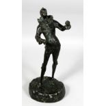 A 19TH CENTURY FRENCH BRONZE OF A JESTER on a rocky base. 12ins high.