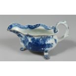 AN EARLY BOW SAUCEBOAT on three paw feet painted in underglaze blue with chrysanthemum and peony and