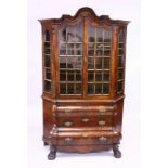 A DUTCH 19TH CENTURY WALNUT VITRINE with domed top, double panel glass doors over a base with