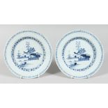 A PAIR OF 19TH CENTURY TIN GLAZE PLATES with buildings, trees, etc.. 9ins diameter.