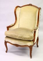 A GOOD CARVED BEECHWOOD ARMCHAIR with wing arms, padded velvet, loose cushion on curving legs.