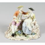 A GOOD FUSTENBERG PORCELAIN GROUP of a young man and girl siting on a bench, a basket of grapes at