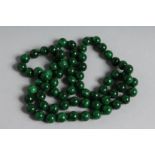 A LONG STRING OF MALACHITE BEADS. 30ins long.