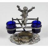 A VICTORIAN METAL DOUBLE SALT, a young boy jumping a style.