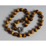 A TIGER'S EYE BEAD NECKLACE. 17ins long,