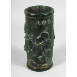 A CHINESE CARVED JADE BRUSH POT carved with BULLS. 8ins high.