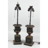 A GOOD PAIR OF BRONZE TWO HANDLED URN LAMPS on pedestal bases.