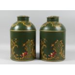 A PAIR OF GREEN TOLEWARE TEA CANISTERS AND COVERS. 14ins high.