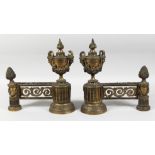 A GOOD PAIR OF LOUIS XVI GILT BRONZE CHENETS with urn finials, masks and pineapple finials. 12ins
