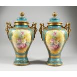 A PAIR OF GERMAN BONN TWO HANDLED VASES with blue and gilt ground painted with reverse panels of