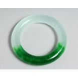 A TWO TONE JADE BANGLE. 3.25ins diameter.