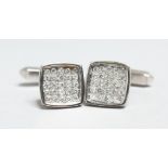 A PAIR OF 18CT WHITE GOLD AND PAVE SET DIAMOND CUFF LINKS.