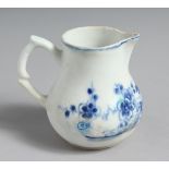 A VERY EARLY BOW CREAM JUG painted in bright blue with flowers and a fence.