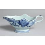 A CHINESE BLUE AND WHITE PORCELAIN SAUCE BOAT, the interior decorated with native flora. 21cm long