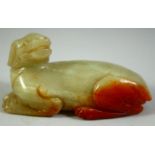 A CHINESE CARVED JADE MODEL OF A RECUMBENT BEAST, 6.5cm long.