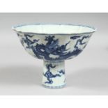 A CHINESE BLUE AND WHITE PORCELAIN PETAL-FORM STEM CUP, the exterior decorated with dragons and