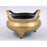 A GOOD CHINESE BRASS TWIN HANDLE TRIPOD CENSER, the base with mark, 14cm diameter.