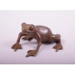 A SMALL JAPANESE BRONZE MODEL OF A FROG, stamped underside, 4cm long.