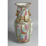 A CHINESE CANTON PORCELAIN VASE painted with panels of figures, along with birds and native flora,