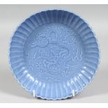 A CHINESE POWDER-BLUE RIBBED PORCELAIN BOWL, the central interior carved with dragon and stylised