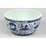 A LARGE CHINESE BLUE AND WHITE PORCELAIN BOWL, the exterior decorated with fish and algae, the rim