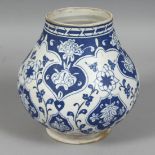 A TURKISH IZNIK BLUE AND WHITE POTTERY VASE, decorated with floral motifs, 16.5cm high.