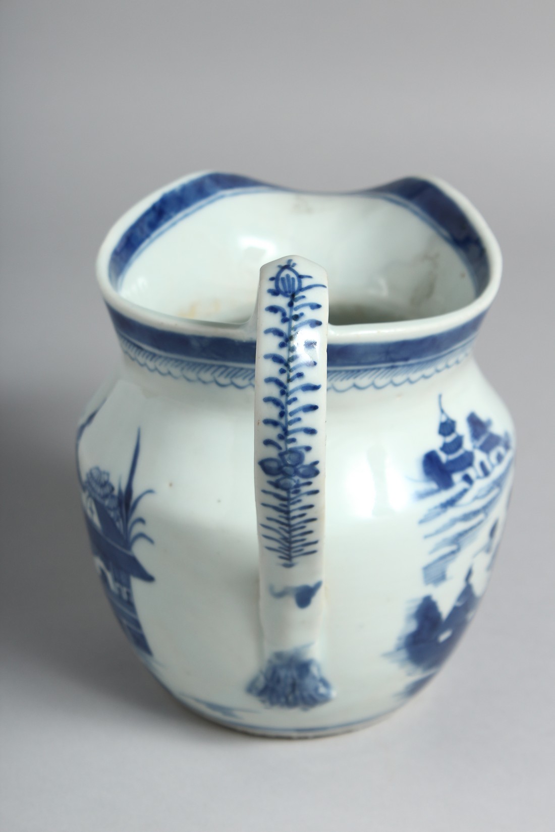 A CHINESE BLUE AND WHITE PORCELAIN JUG decorated with a landscape scene with boats and buildings. - Image 2 of 5