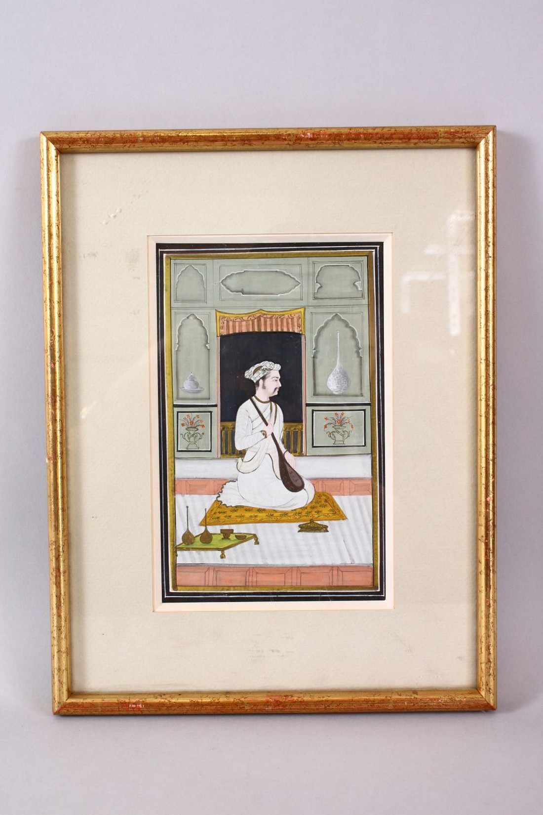 AN INDIAN MINIATURE PAINTING depicting a seated prince holding a sitar, image size 18cm x 11cm. - Image 2 of 2