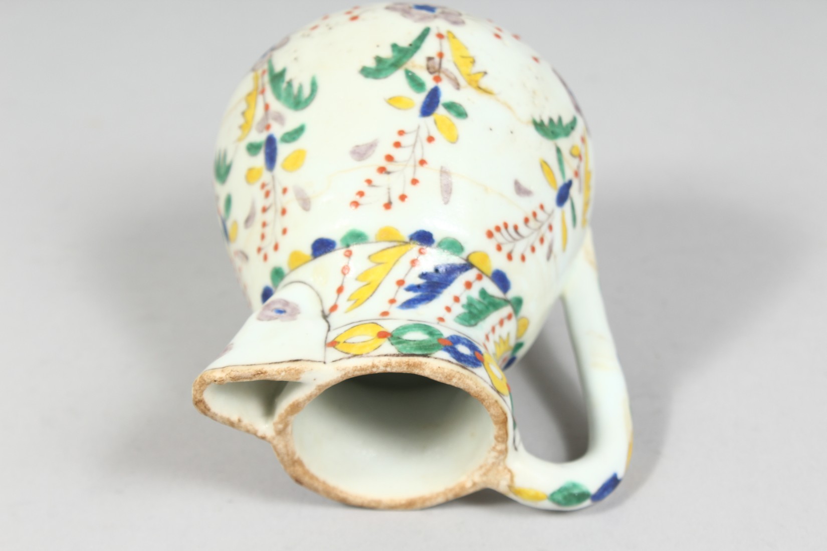 A SMALL TURKISH KUTAYHA POTTERY JUG, decorated with floral motifs, 12cm high. - Image 5 of 6