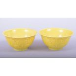 A PAIR OF CHINESE YELLOW GLAZED PORCELAIN CUPS, each with six character mark to base, 7.5cm