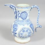 A TURKISH KUTAYHA BLUE AND WHITE POTTERY WATER JUG, with raised decoration and painted with