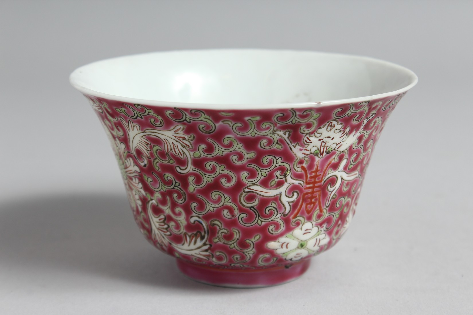 A CHINESE PINK GROUND PORCELAIN ENAMELLED BOWL with stylised floral motifs and vine, the base with - Image 2 of 6