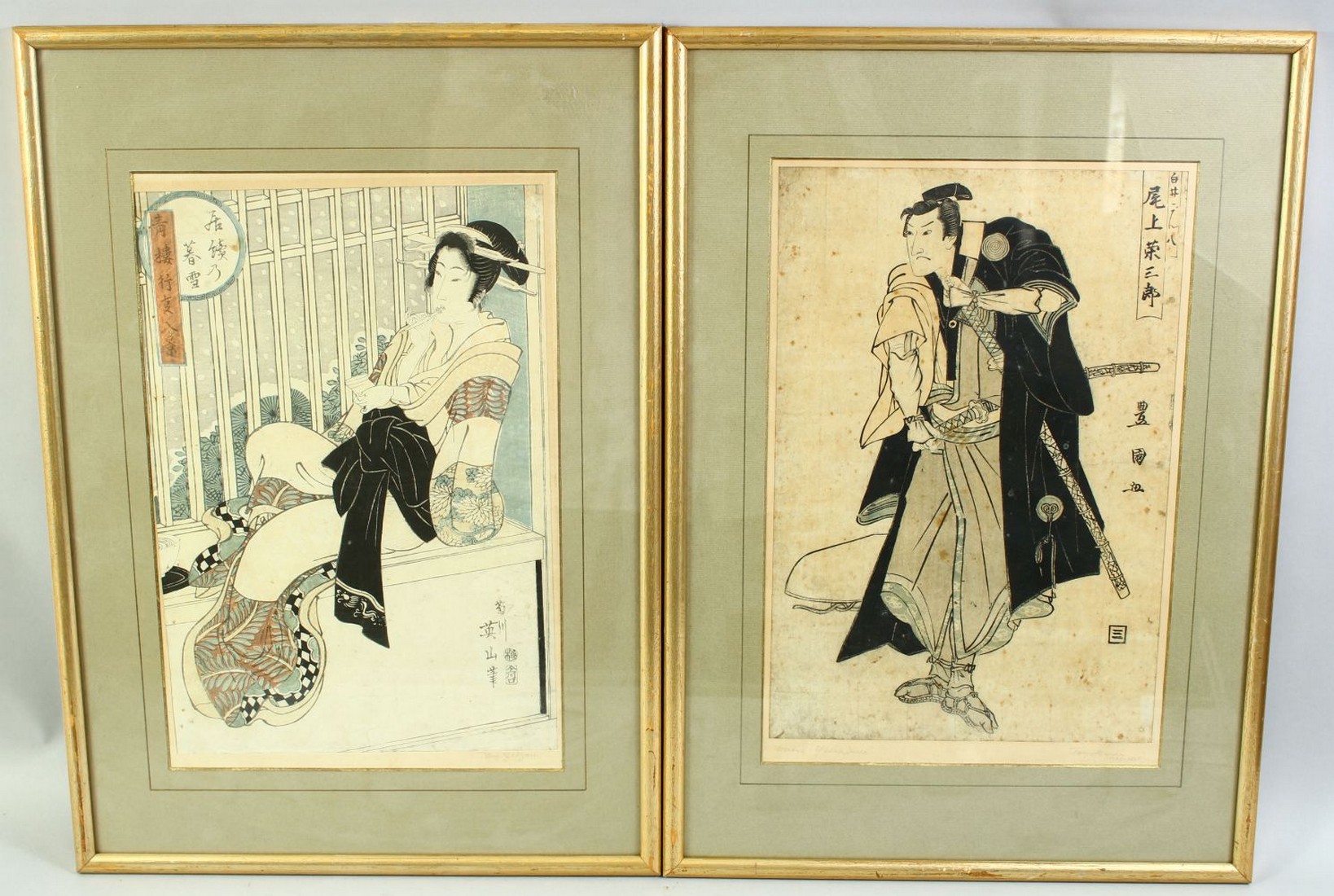 TWO JAPANESE WOODBLOCK PRINTS, one depicting a male actor with ceremonial robes and swords, the