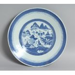 A CHINESE BLUE AND WHITE PORCELAIN DISH, the central roundel containing a landscape scene