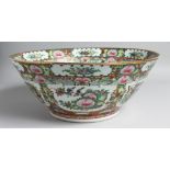A LARGE CHINESE CANTON PORCELAIN PUNCH BOWL, painted with multiple panels of floral motifs and