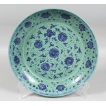 A CHINESE TURQUOISE-GROUND BLUE AND WHITE PORCELAIN DISH, decorated with stylised flowerheads and